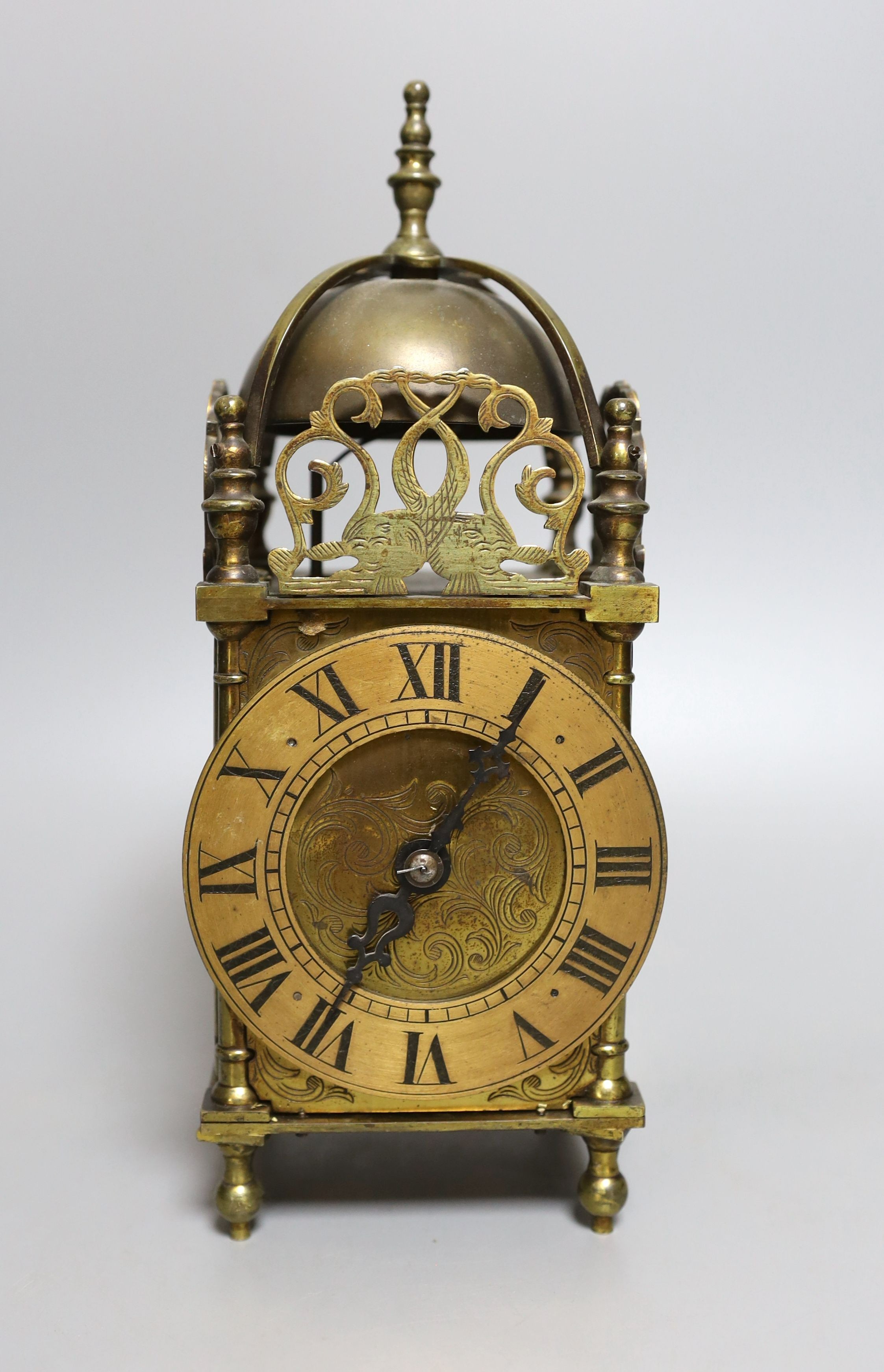 A 19th century miniature brass lantern clock, with key. 24cm